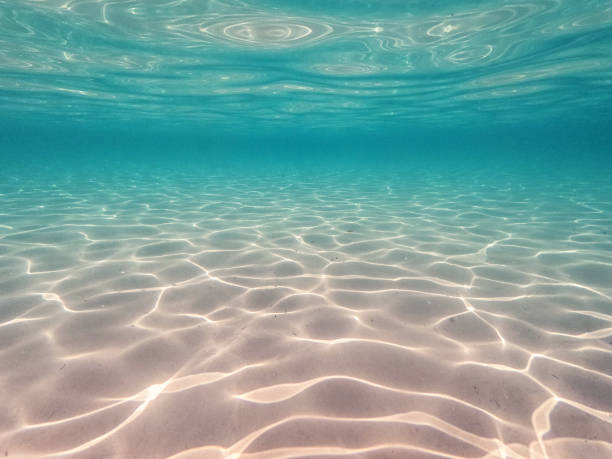 Underwater view in crystal clear lagoon with white sand on a Greek island