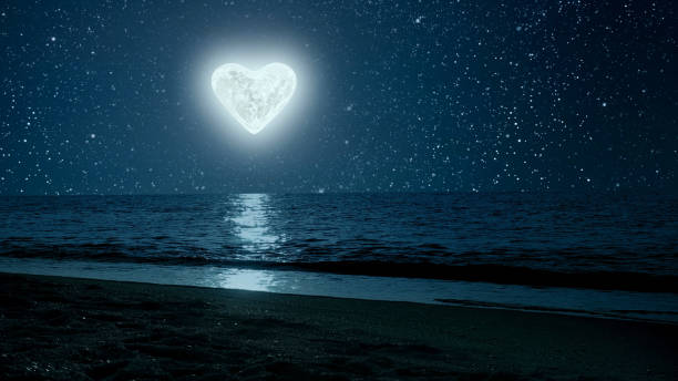 a moon heart-shaped shines over sea on valentine's day